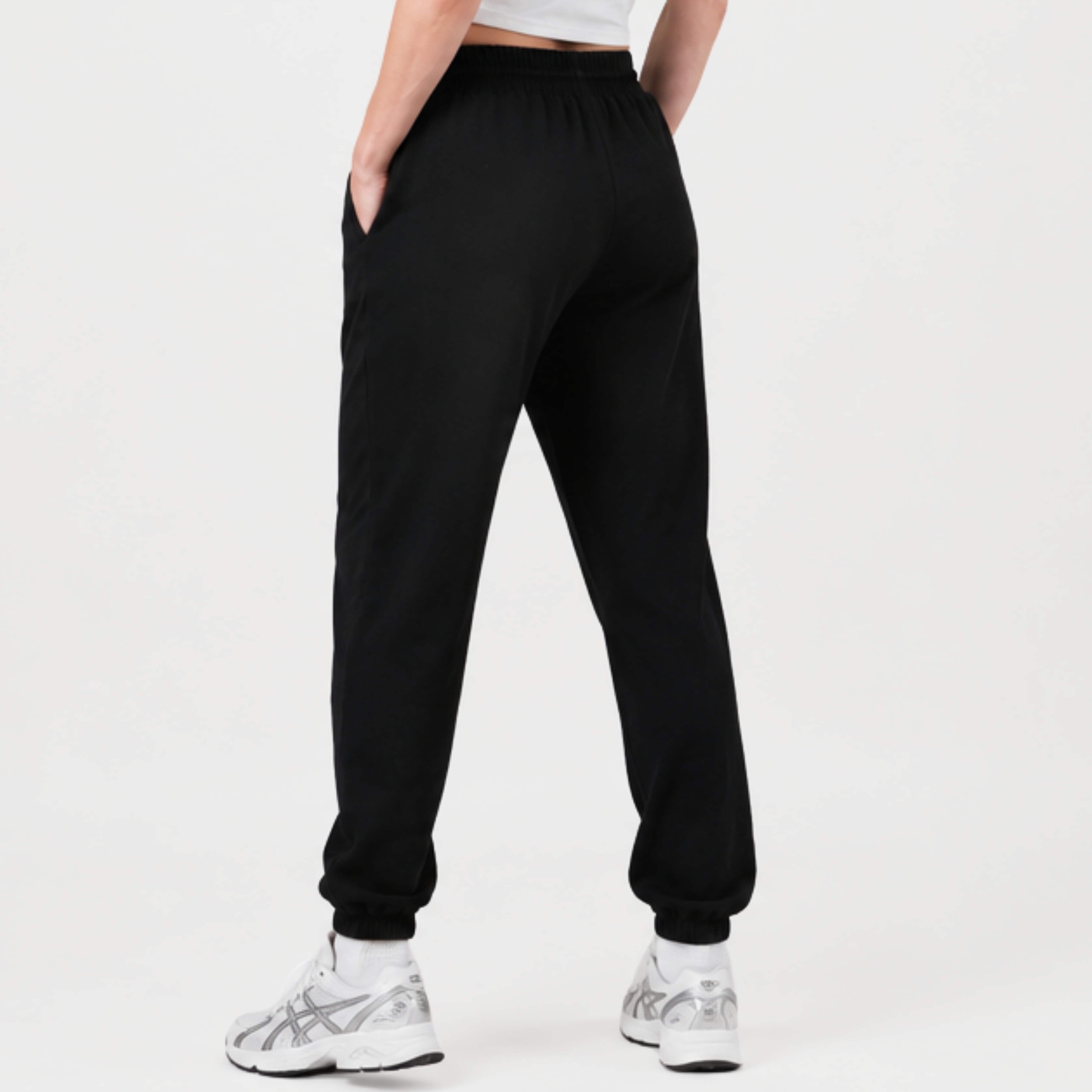 Person wearing a black  Kovered leakproof trackies on a white background