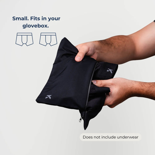 Man placing leakproof boxer briefs into the Kovered small dual-pocket DryBag — discreet waterproof bag for spare underwear glove box or bag